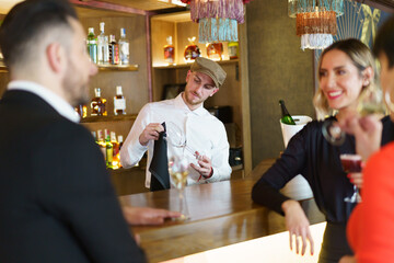 Company of elegant friends gathering in bar
