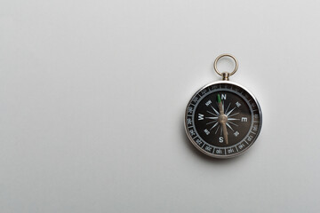 Silver compass on color background. Top view - obrazy, fototapety, plakaty