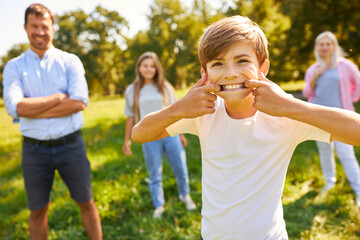 Fototapeta premium Boy making faces in a meadow