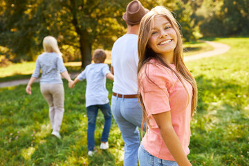 Teenagers with family in the park on an outing