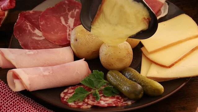 charcuterie platter with potatoes and melted cheese