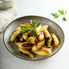 Traditional German potato dumplings with fried onion