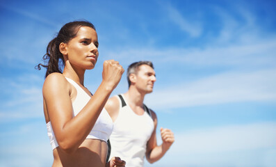 Fototapeta premium Getting fit together. Shot of two people running outdoors.