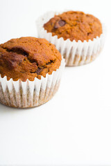 pair of chocolate muffins on white table