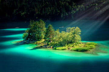 Sunbeams over an island in the Eibsee Lake, Bavaria, Germany