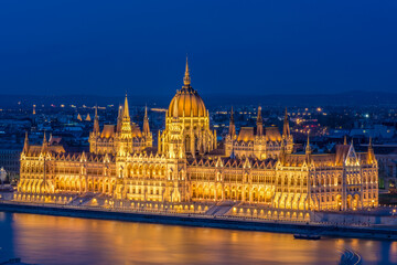 Fototapeta na wymiar The Hungarian Parliament illuminated at night over the Danube, Hungary