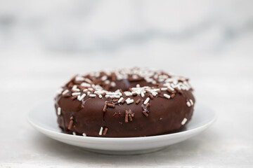 Fototapeta na wymiar chocolate doughnut on small dish on ceramic