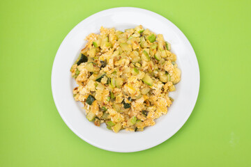 scrambled egg with zucchini on white small plate