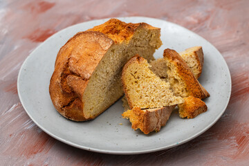 typical portuguese corn bread on gray plate on brown