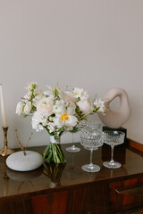 Wedding bouquet stands on a table with glasses
