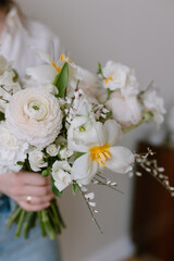 Beautiful bouquet in female hands. The florist is holding flowers.