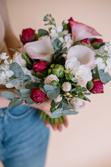 The original bouquet of flowers in the hands of women