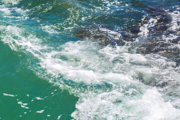 Rough sea close up selective focus. Beautiful blue waves with a lot of sea foam scene looked from above, close up. foam on the blue sea. Beauty