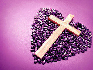 Lent Season,Holy Week and Good Friday concepts - photo of wooden cross in purple vintage background. Stock photo.