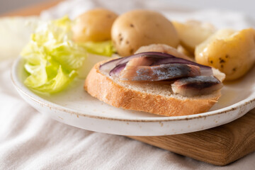 Food photography. Serving option. Salted herring with boiled potatoes and red onions. Dinner.