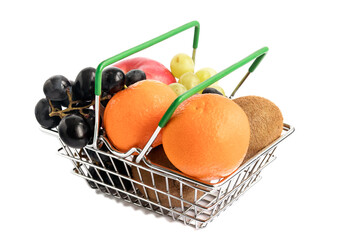 In a trading metal basket there are fresh various fruits - tangerines, grapes, kiwi, apples. 