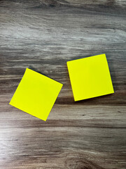 yellow sticky notes on wooden tabletop 