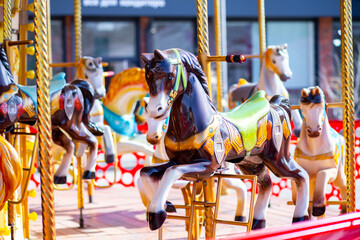 Amusement park carousel with beautifully painted wooden horses