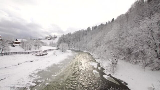 River Prut with snowy shores in ukrainian Vorokhta in winter