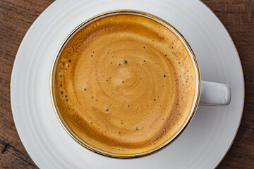 cup of espresso on wooden background top view
