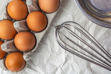 eggs whisk and bowl top view close up