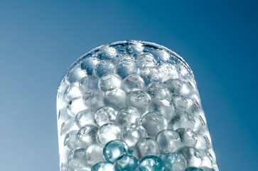 Hydrogel balls in a glass vase. Hydrogel as an art object or background for a computer desktop. Hydrogel close-up.