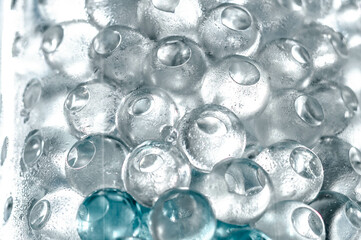 Hydrogel balls in a glass vase. Hydrogel as an art object or background for a computer desktop. Hydrogel close-up.