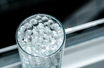 Hydrogel balls in a glass vase. Hydrogel as an art object or background for a computer desktop. Hydrogel close-up.