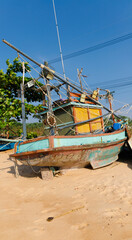 Fototapeta na wymiar old and rotten fishing boat at a thailand beach