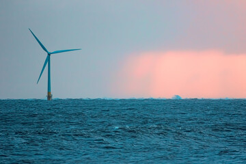 Single offshore wind turbine. Beautiful alternative energy landscape background image