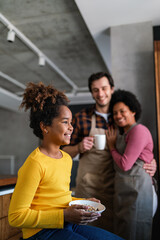 Happy multiethnic family in love together in kitchen. Parents child together concept