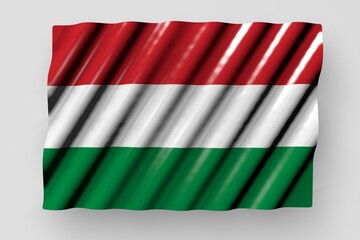 nice glossy flag of Hungary with large folds lying flat isolated on grey - any feast flag 3d illustration..