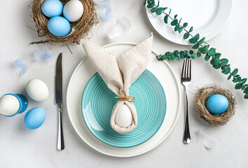 Easter bunny made of eggs and napkins on a plate.