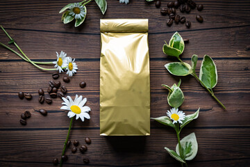Mock-up golden metallic paper pouch bag on dark wooden table lying at coffee beans