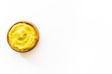 Green guacamole avocado dip in bowl, top view