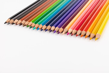 Many multicolored pencils, isolated on white background with copy space. Art and education background.