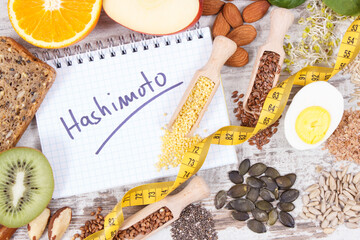 Notepad with inscription hashimoto and best ingredients or products for healthy thyroid. Food containing vitamins