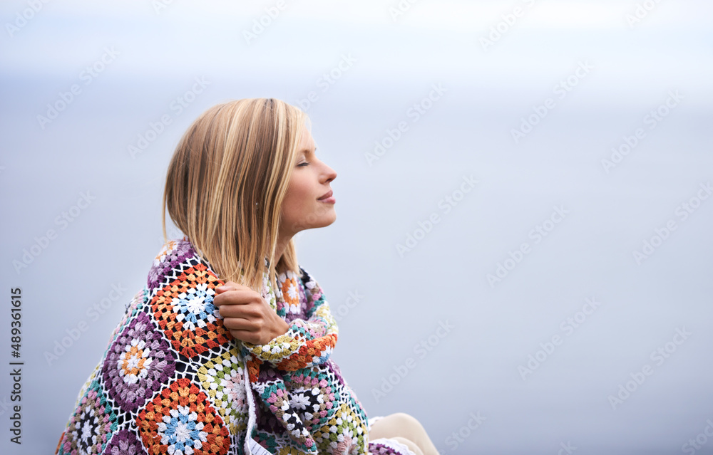 Sticker Morning contemplation. Shot of a beautiful young woman standing at the ocean.