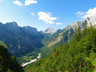 Fototapeta na wymiar Scenic view of mountain Bavski Grintavec and Zadnja Trenta valley, Slovenia and slopes covered in larch trees