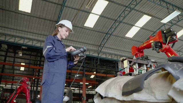Diversity team of factory engineers ,leadership by engineer women are inspecting and consulting work inside the factory wearing safety clothing according to industrial safety standards.
