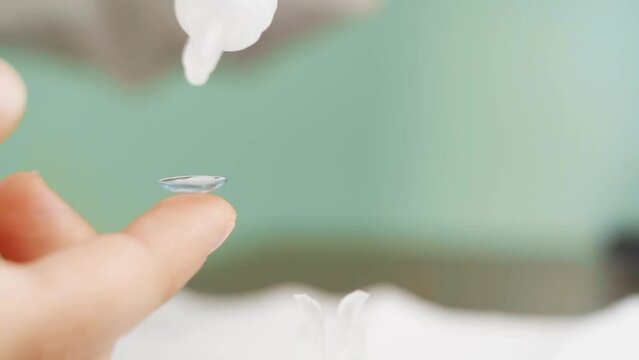 close-up. on contact lens on a child's finger drip eye drops. 