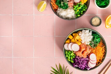 Hawaiian poke bowl with salmon in a bowl with seaweed, sesame seeds and cabbage. Top view, flat lay,