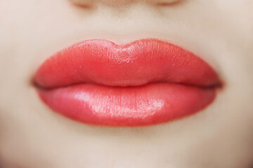Close-up of lips after tattoo with coloring pigment, permanent makeup of woman's lips in beauty salon, beauty and health - obrazy, fototapety, plakaty