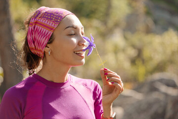 A girl sniffs the scent of spring wildflowers