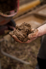 Building a House with Straw Clay -  mixing ingredients on the building site. Ancient techniques of traditional architecture.