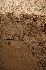 Building a House with Straw Clay -  mixing ingredients on the building site. Ancient techniques of traditional architecture.