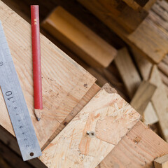 Traditional joinery in wooden architecture -  skilled carpenter working site - with ruller and pencil.