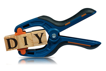 Fototapeta premium Close-up of a spring plastic clamp and text Diy (do it yourself), made of wooden blocks, isolated on white background.
