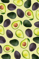 Slices and half of avocado on a yellow wallpaper background.