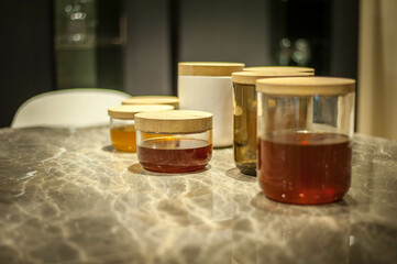 group of jars with jam and honey on a marble work top
group of jars with jam and honey on a marble work top